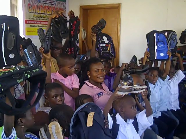 OVC display their school bags, shoes and uniforms during SOWCHAN Children's Day celebration. Supported by Chevron Nigeria and Africa Women Development Fund (AWDF).