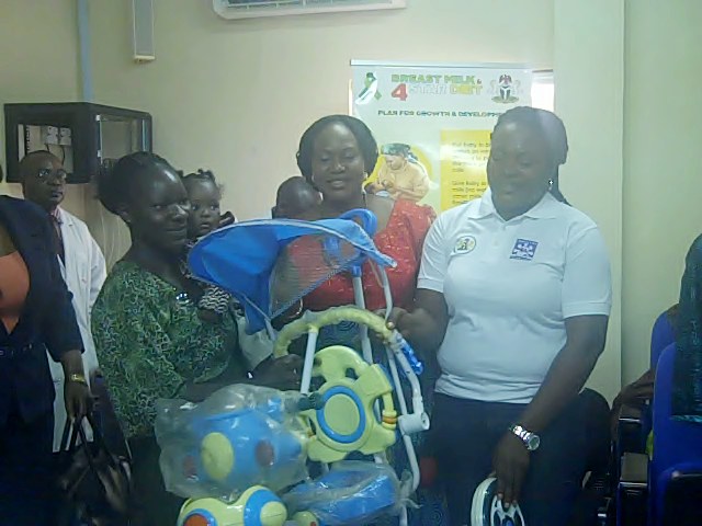 SOWCHAN FCT Financial Secretary Sarah Francis wins and is presented with a child's bicycle by a staff of the Federal Ministry of Health for passing an exclusive breastfeeding interview during Breastfeeding Week, National Hospital FCT, Abuja.